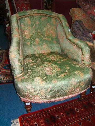 Appraisal: A Victorian armchair with turned mahogany legs terminating in ceramic