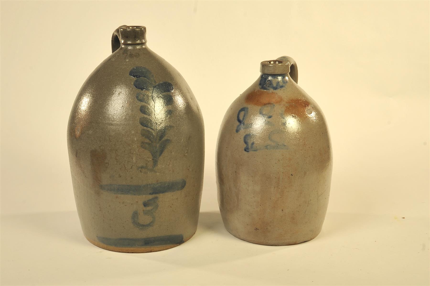 Appraisal: TWO STONEWARE JUGS WITH COBALT FREEHAND DECORATION American th quarter-