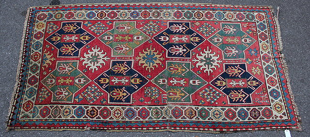 Appraisal: AN OLD POSSIBLY TURKISH RED GROUND RUG with geometric designs