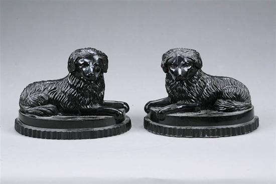 Appraisal: TWO GLASS DOGS Matching black glass seated dogs on oval