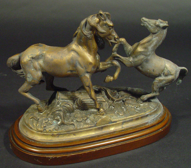 Appraisal: Cast brass group of horses on a turned mahogany stand