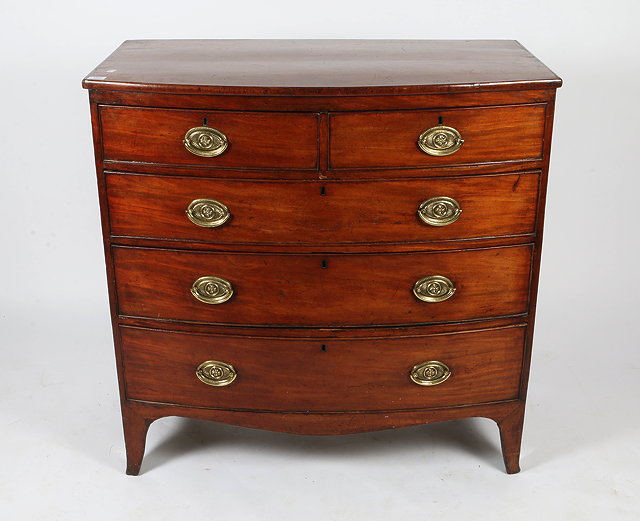 Appraisal: A GEORGE III MAHOGANY BOW FRONTED CHEST of two short