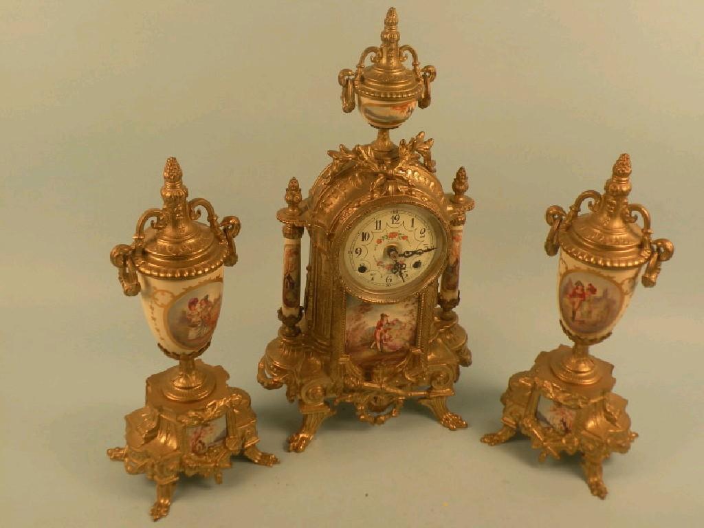 Appraisal: A continental gilt metal garniture mantel clock with transfer printed