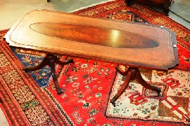 Appraisal: A mahogany coffee table in Georgian taste with tooled leather