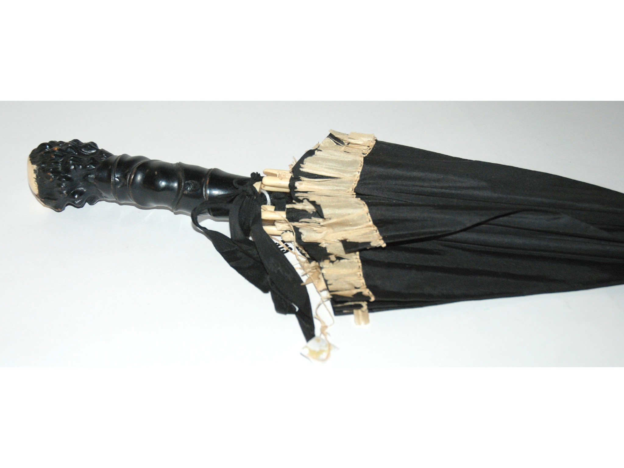 Appraisal: A Victorian ebony carved handle umbrella