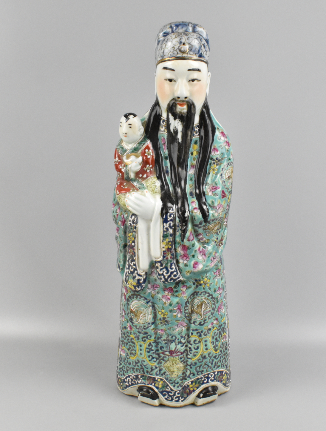 Appraisal: A Chinese famille rose figure holding a boy dating from