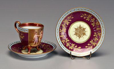 Appraisal: Royal Vienna cup and saucer porcelain cup with tripod scrolled