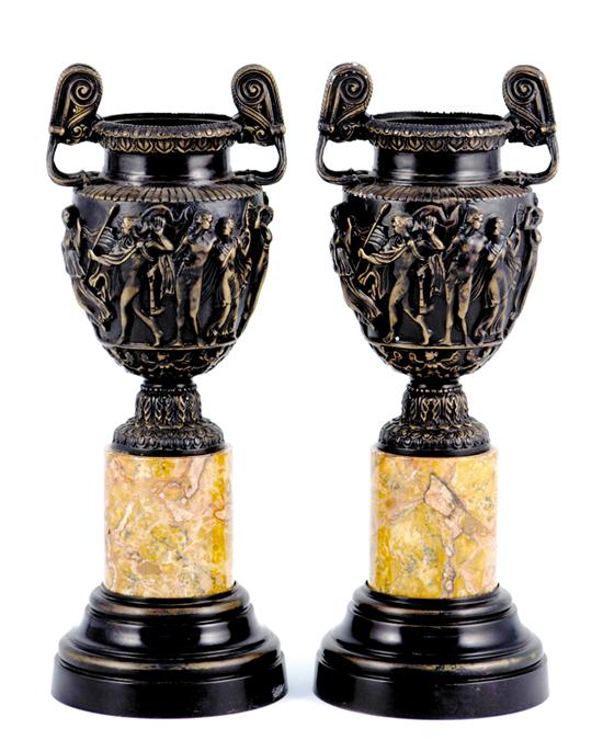 Appraisal: Pair Warwick style bronze vases figural relief molded scene adorned