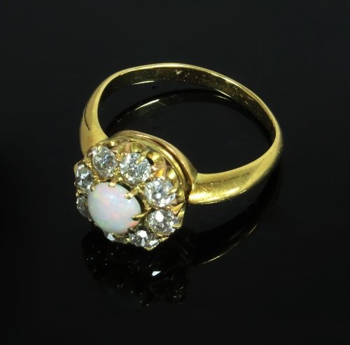 Appraisal: An opal and diamond cluster ring the central opal to