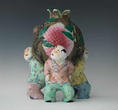 Appraisal: A Chinese Figurine of Three Children with Pomegranate Hand-painted ceramic