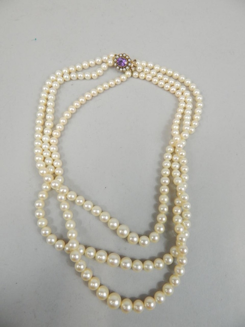 Appraisal: A three strand cultured pearl necklace with clasp stamped ct