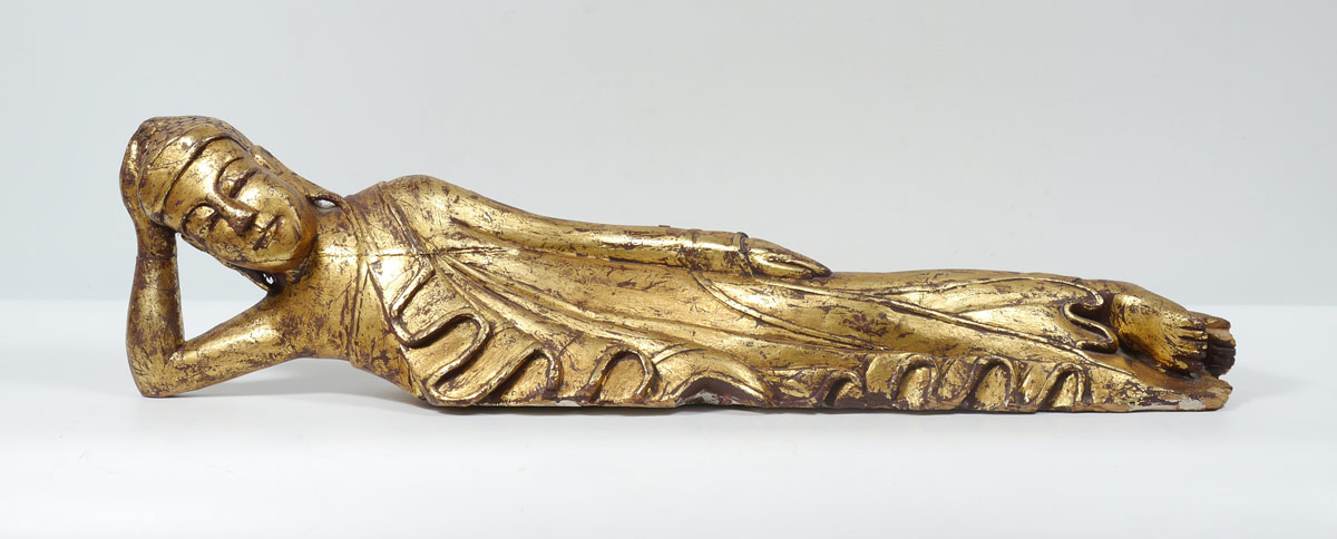 Appraisal: CARVED AND GILT DECORATED RECLINING BUDDHA Figure of Buddha in