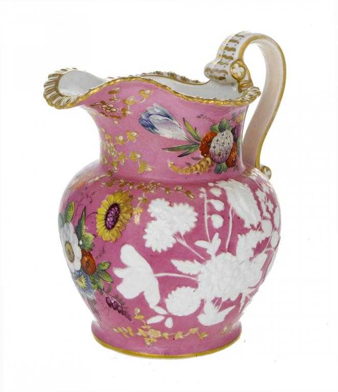 Appraisal: A COALPORT PINK GROUND MOULDED JUG painted and gilt with