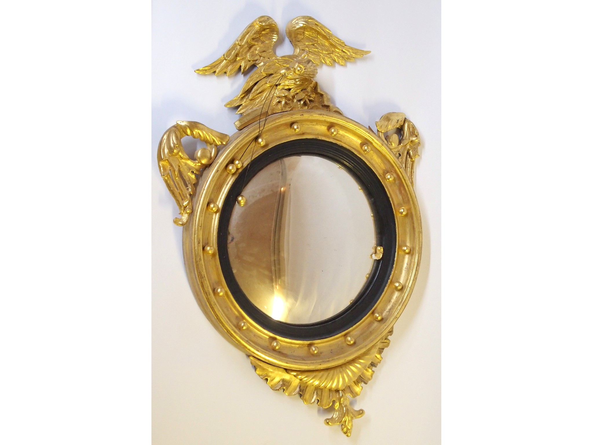 Appraisal: A th Century giltwood and gesso convex circular wall mirrorwith