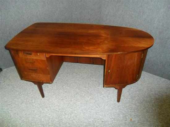 Appraisal: A DANISH ROSEWOOD KNEEHOLE DESK with four drawers and a