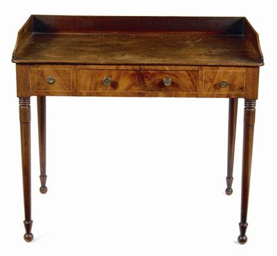 Appraisal: An early th century mahogany washstand fitted a central frieze