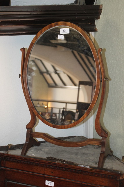 Appraisal: AN EDWARDIAN MAHOGANY SWING OVAL DRESSING TABLE MIRROR