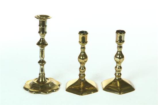 Appraisal: THREE BRASS CANDLESTICKS Probably England late th-early th century Single