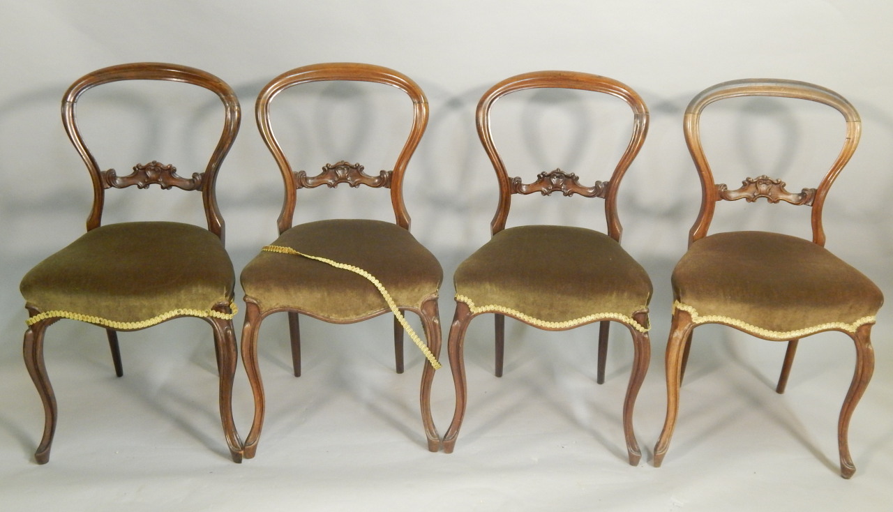 Appraisal: A set of four Victorian rosewood balloon back chairs each