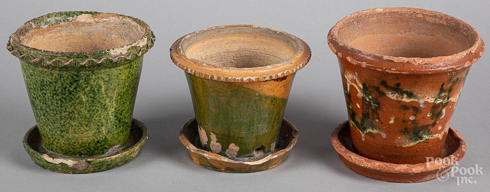 Appraisal: Three Pennsylvania redware flowerpots Three Pennsylvania redware flowerpots th c