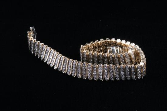 Appraisal: K YELLOW GOLD AND DIAMOND BRACELET Composed of vertical rows