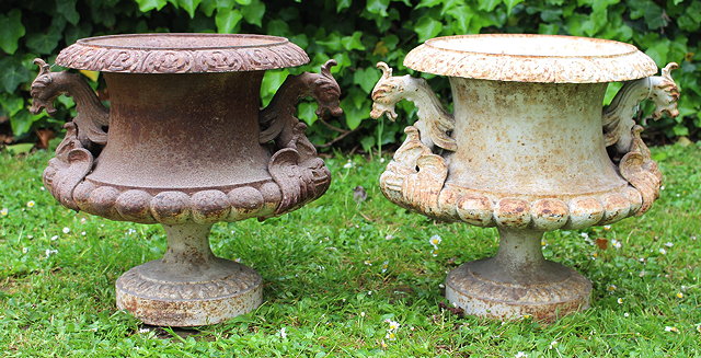 Appraisal: A PAIR OF SMALL CAST IRON URNS with griffin mask