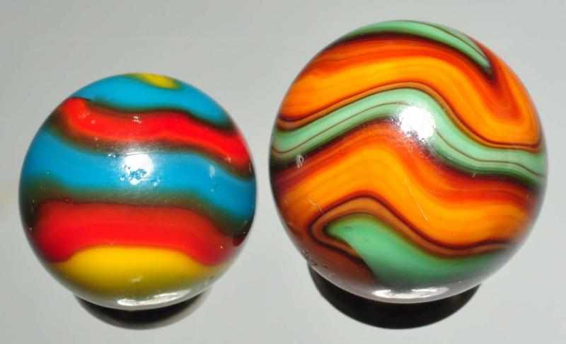 Appraisal: Lot of Machine Made Marbles Description Smaller marble is a