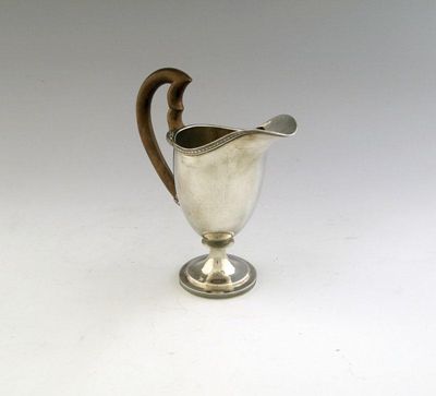 Appraisal: An early th century Swiss helmet shaped milk jug curved