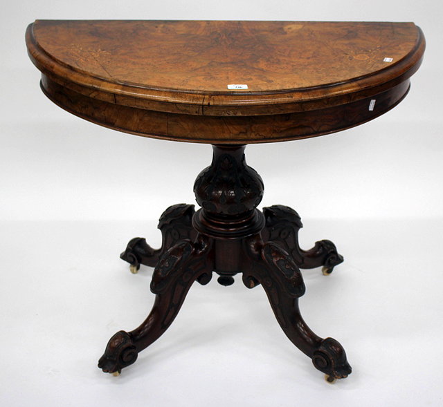 Appraisal: A VICTORIAN WALNUT DEMI-LUNE CARD TABLE with inlaid decoration to