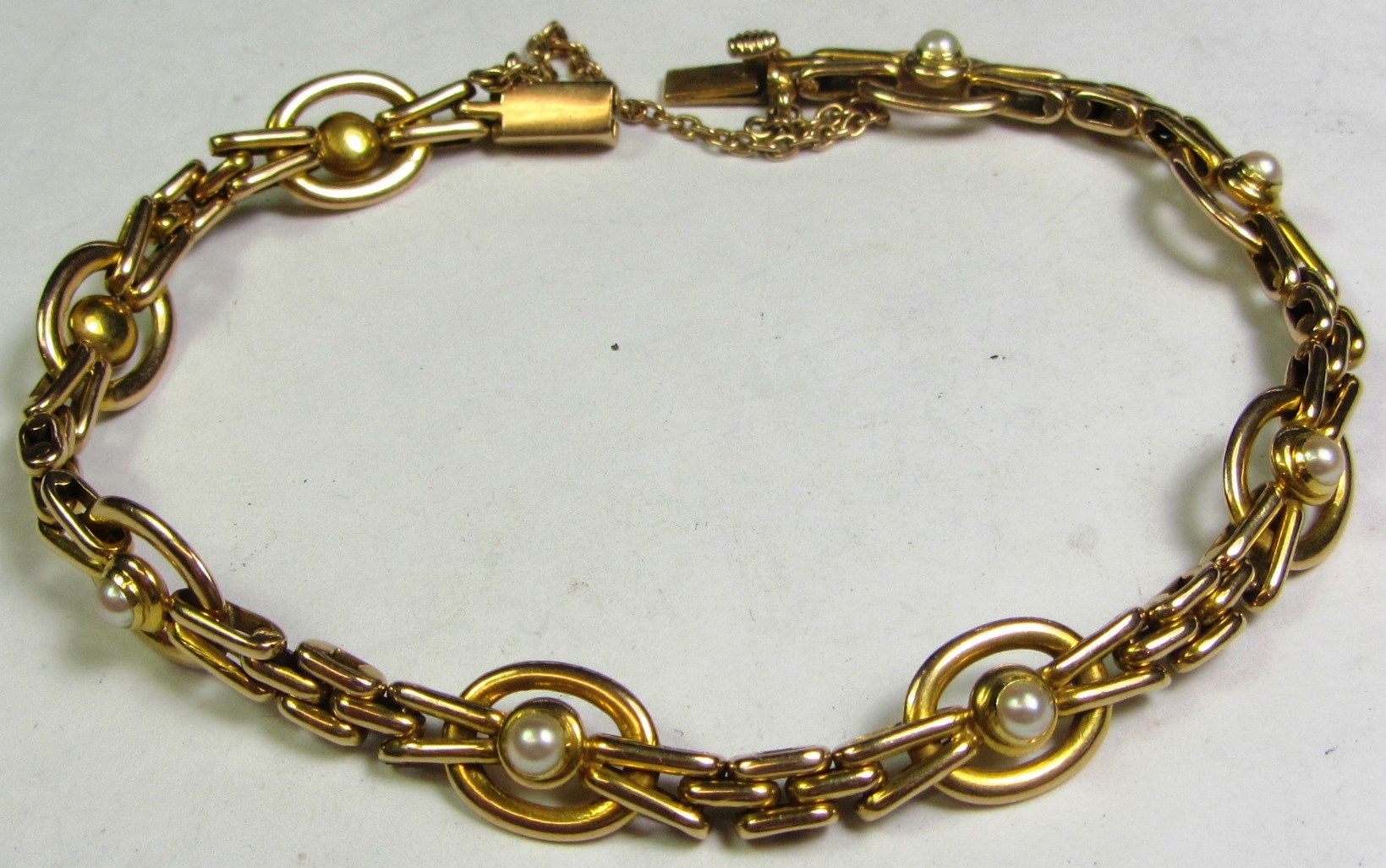 Appraisal: A gold and half pearl set bracelet in a bar