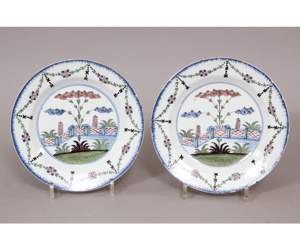 Appraisal: Pair of English Delft plates th c polychrome decorated with