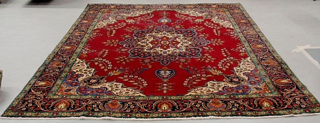 Appraisal: Kashan room size oriental carpet red field center medallion and