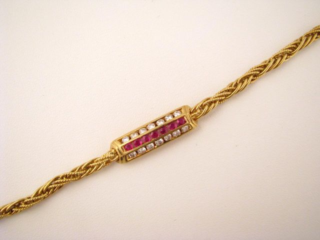 Appraisal: k Yellow gold bracelet with diamond and ruby center bar