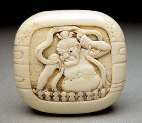 Appraisal: ANTIQUE IVORY MANJU Antique carved ivory manju netsuke of rounded