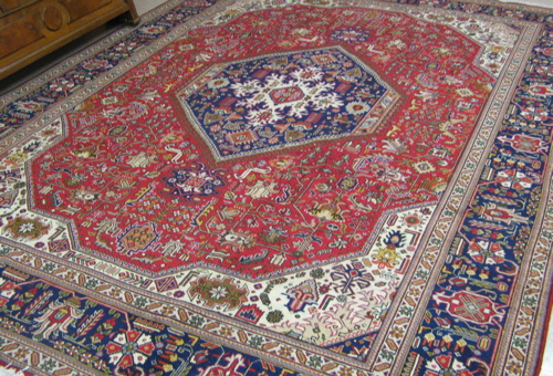 Appraisal: PERSIAN TABRIZ CARPET decorated with stylized flowers that fill the