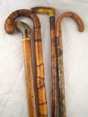 Appraisal: Four walking sticks comprising an Alpenstock with applied badges a