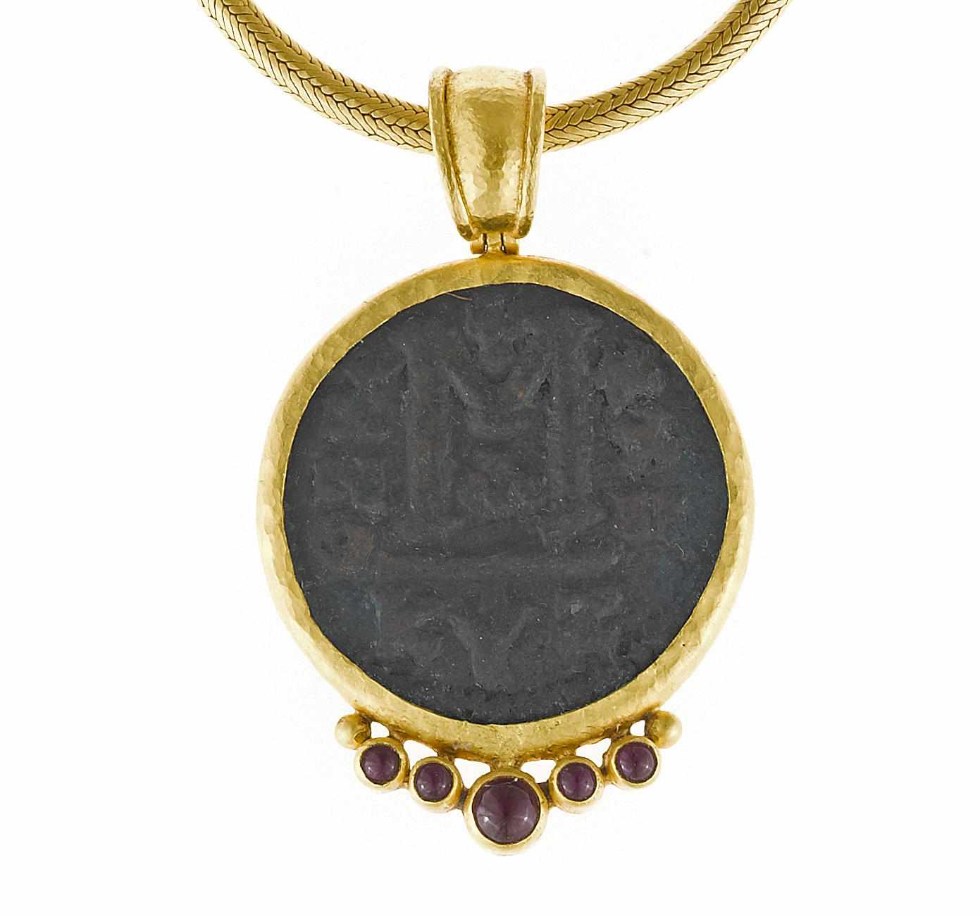 Appraisal: A coin ruby and high karat gold pendant with chain