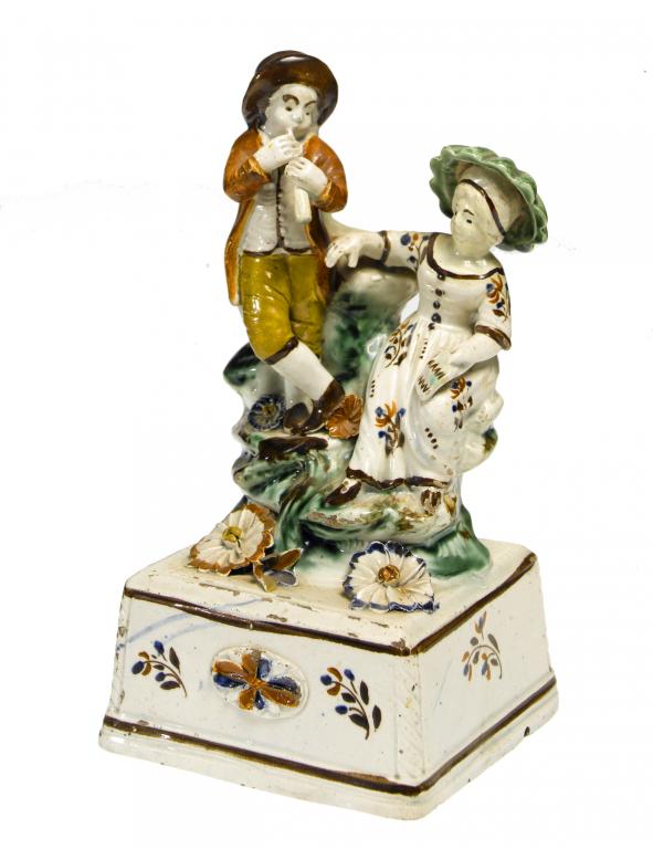 Appraisal: A PEARLWARE GROUP OF MUSICIANS STAFFORDSHIRE OR YORKSHIRE the piper