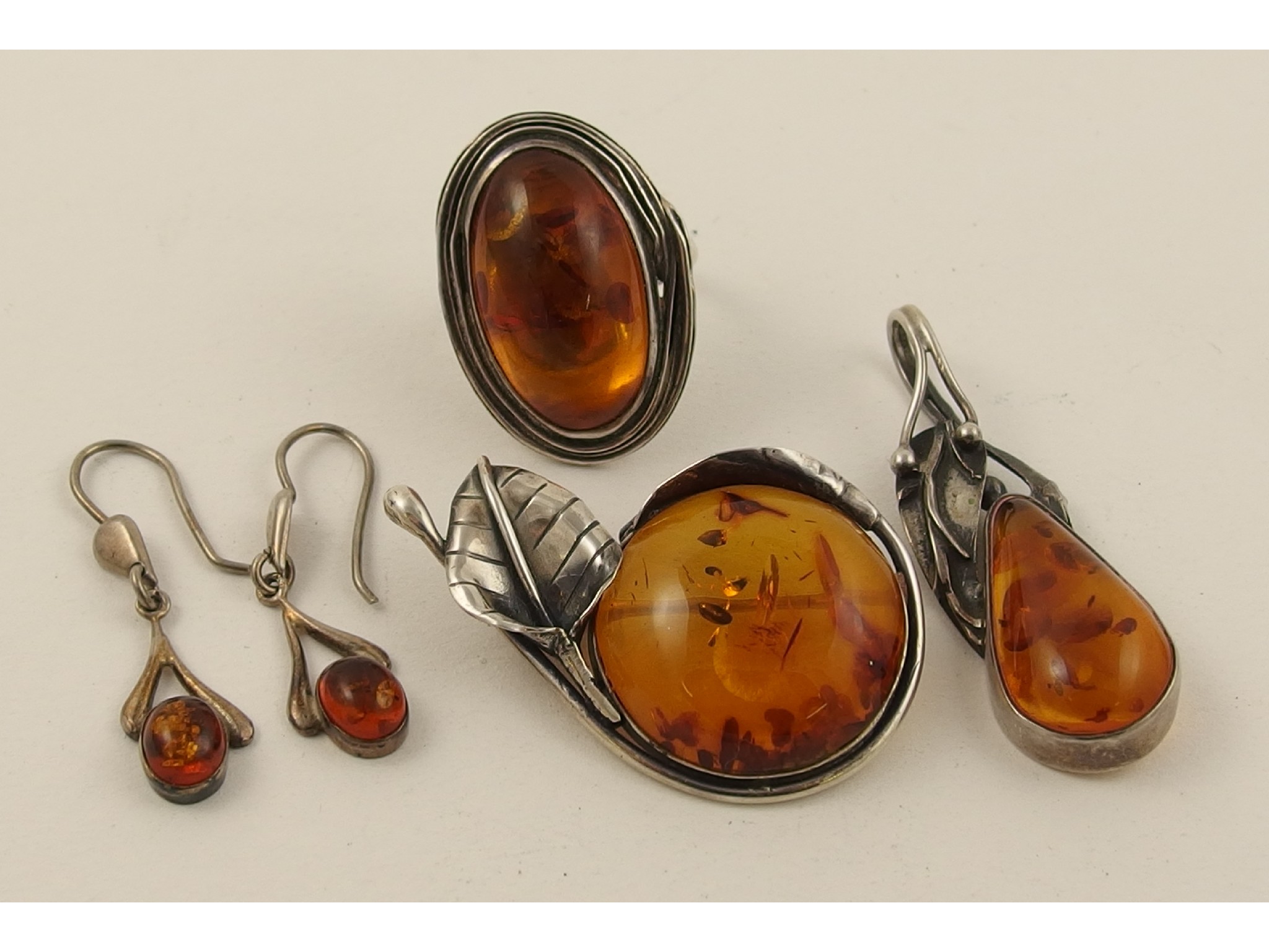 Appraisal: A collection of white metal amber coloured jewellery