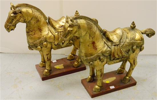 Appraisal: Two Chinese style gilt wooden horses on red oblong bases