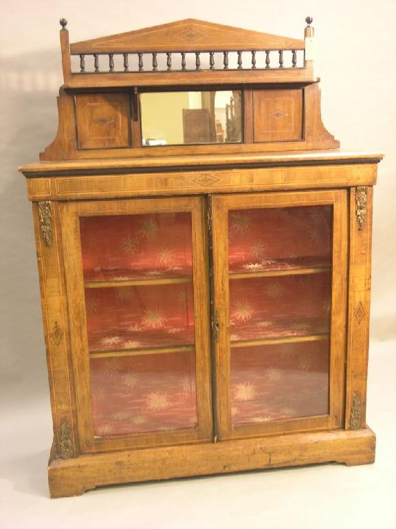 Appraisal: A Victorian inlaid walnut display cabinet arched raised back with