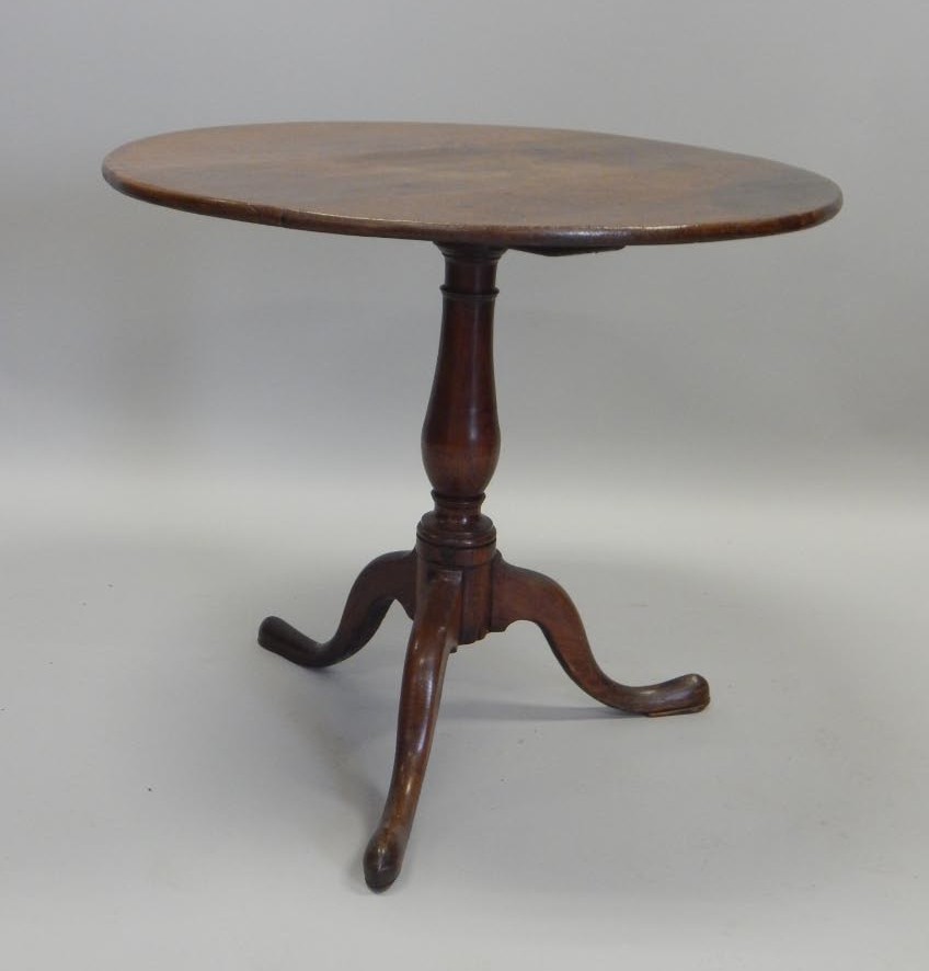 Appraisal: A thC oak occasional table the circular tilt top on