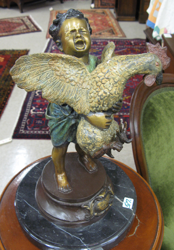 Appraisal: BRONZE FIGURE young boy crying and holding a chicken with