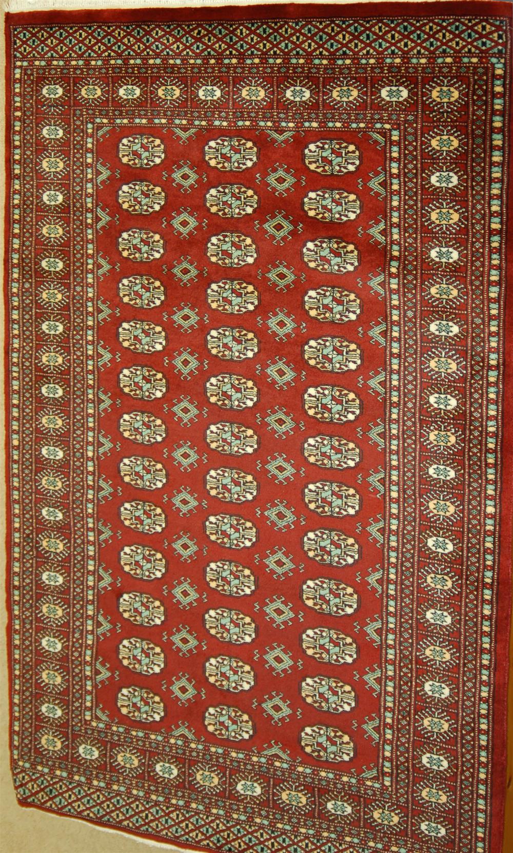 Appraisal: HANDMADE PAKISTANI BOKHARA RUG wool with red ground approx '