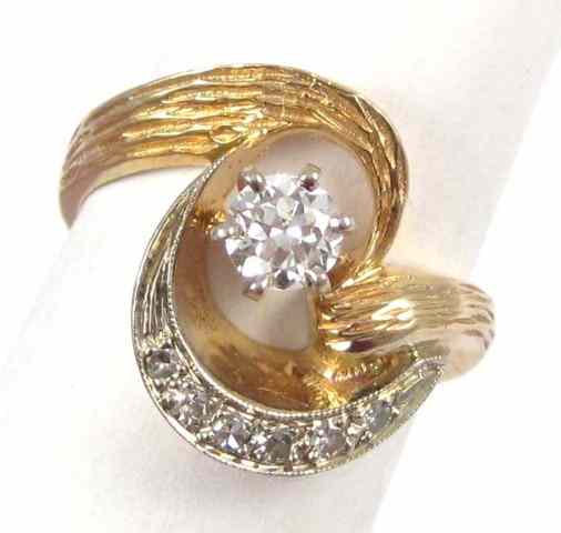 Appraisal: DIAMOND AND FOURTEEN KARAT GOLD RING raised above six smaller