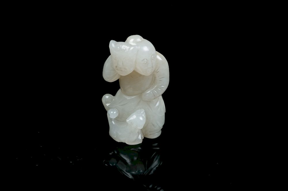 Appraisal: A CARVED JADE BOY QING The jade finely carved with