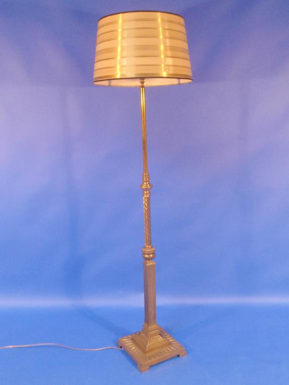 Appraisal: A candy twist and columnar brass standard lamp converted for