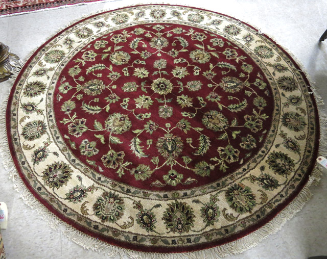 Appraisal: A ROUND ORIENTAL AREA RUG Indo-Persian overall foliate design on