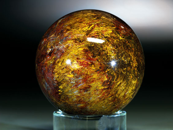 Appraisal: ORANGE AND YELLOW PIETERSITE SPHERE A variety of Tiger-eye Drom