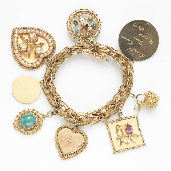 Appraisal: A gem-set and fourteen karat gold charm bracelet suspending eight